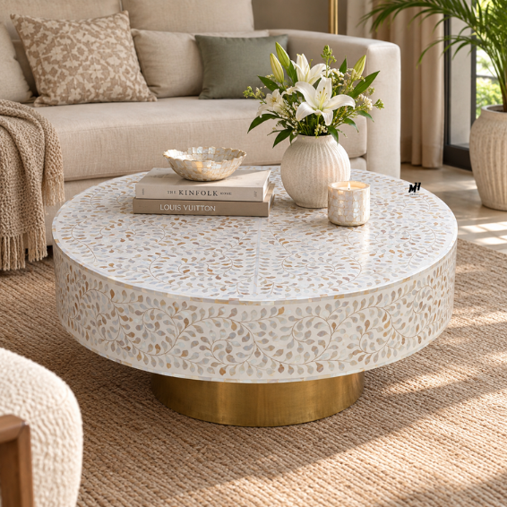 Round mother of pearl coffee table with white floral inlay pattern and brass base