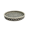 Round black and white bone inlay serving trays in geometric pattern