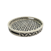 Round black and white bone inlay serving trays in geometric pattern