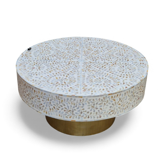 Round mother of pearl coffee table with white floral inlay pattern and brass base