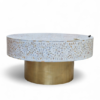 Round mother of pearl coffee table with white floral inlay pattern and brass base
